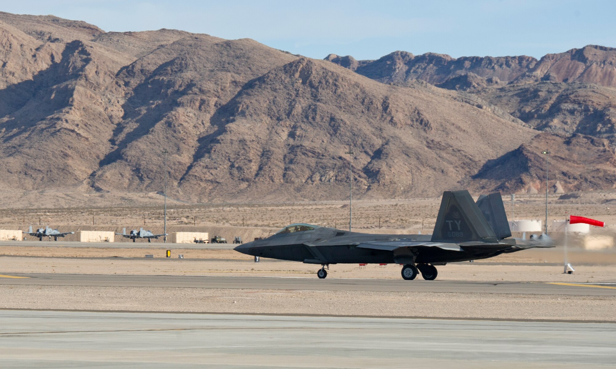 An F-22 Raptor assigned to the 95th Fighter Squadron, Tyndall AFB, Fla. takes off on the first day of Red Flag 16-1, Jan. 25 on the Nellis AFB, Nev. flightline. Tyndall’s F-22 Raptors bring a lot to the exercise as the jet’s stealth capabilities, advanced avionics, communication and sensory capabilities help augment the capabilities of the other aircraft. (U.S. Air Force photo by Senior Airman Alex Fox Echols III/Released)  