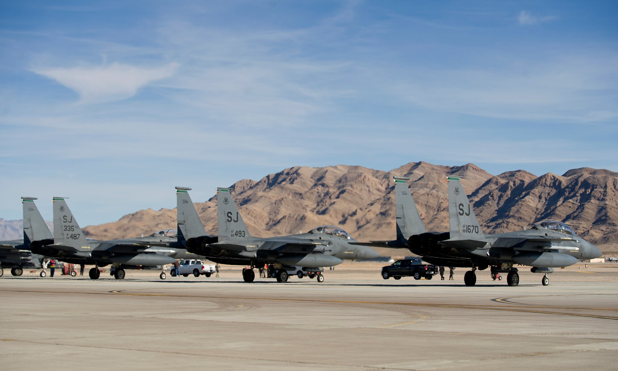 Three F-15E Strike Eagles from Seymour Johnson AFB, N.C., sit on the flightline before takeoff during the first day of Red Flag 16-1, Jan. 25 at Nellis AFB Nev. More than 130 aircraft and 3,000 personnel from more than 30 units including squadrons from Australia and the United Kingdom have arrived at Nellis to participate in the most realistic combat training available. (U.S. Air Force photo by Senior Airman Alex Fox Echols III/Released)  