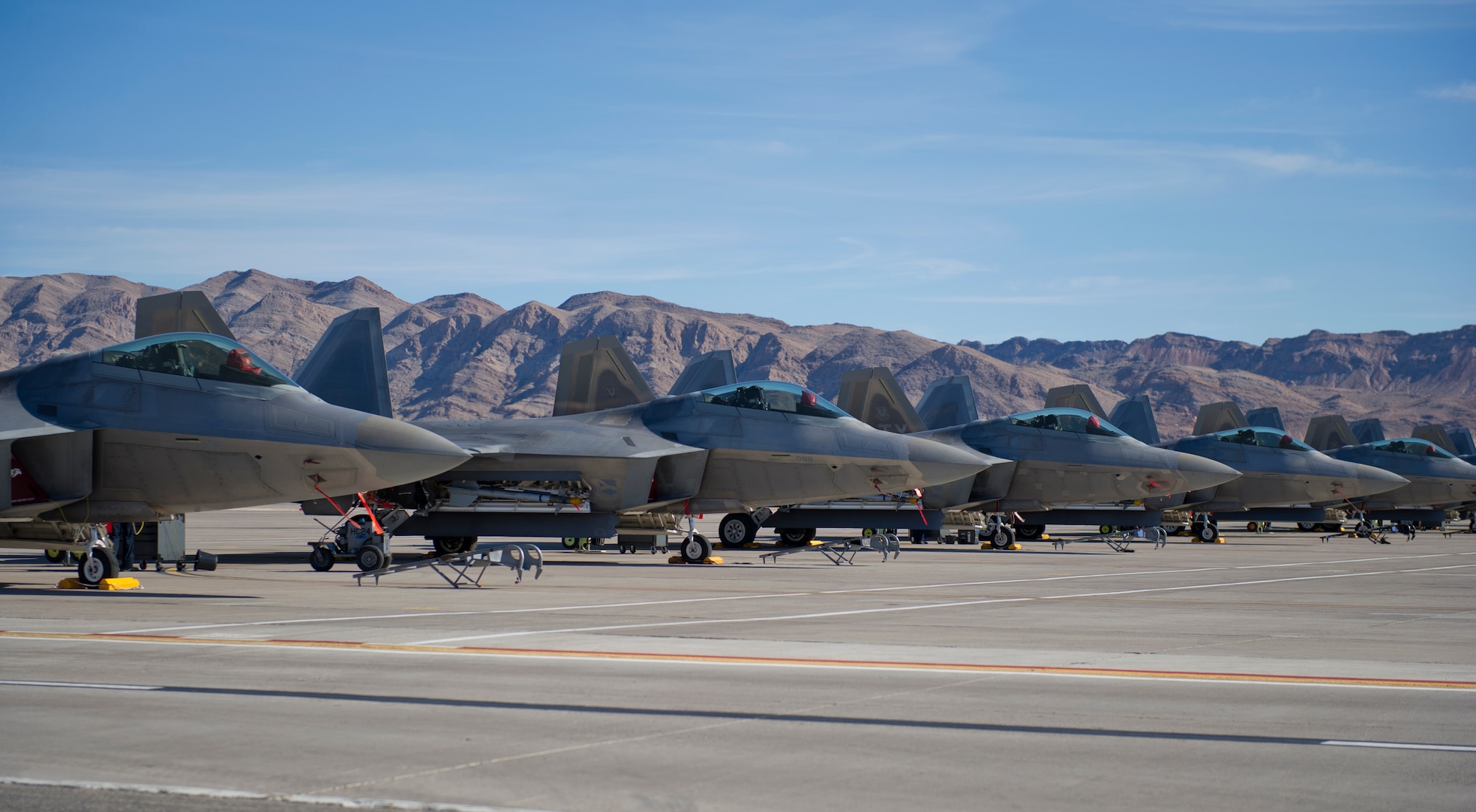 Five F-22 Raptors from Tyndall AFB, Fla. sit on the flightline during the first day of Red Flag 16-1, Jan. 25 at Nellis AFB, Nev. Red Flag is a joint, full-spectrum, readiness exercise designed to provide the most realistic combat training available. (U.S. Air Force photo by Senior Airman Alex Fox Echols III/Released)  