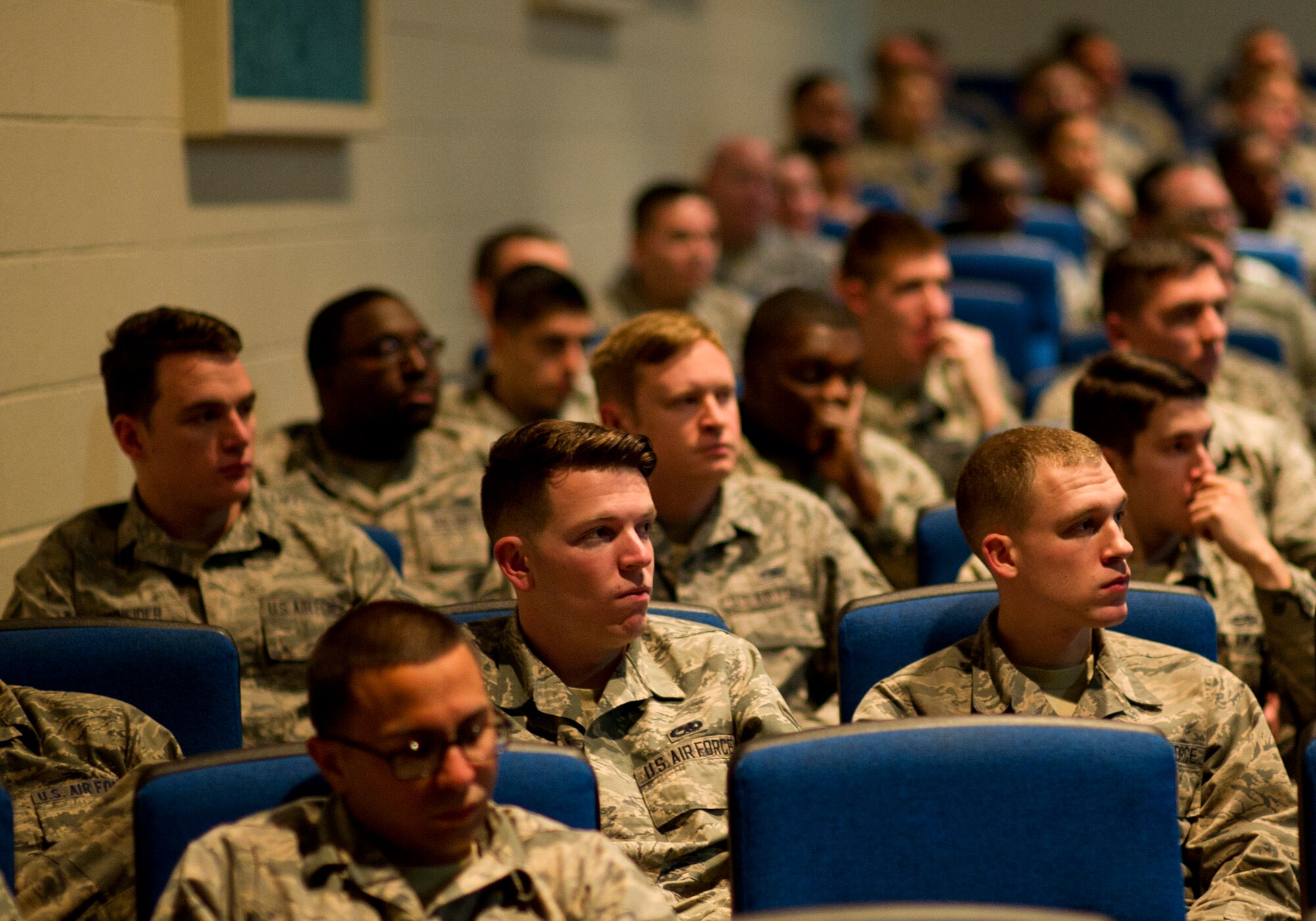 Participants of Red Flag 16-1 listen to Colonel Derek C. France, 325th Fighter Wing commander and Red Flag 16-1 Air Expeditionary Wing commander, as he briefs Jan. 24 at the Nellis AFB theater. During the brief, Airmen learned the purpose of Red Flag and things to keep in mind when taking part in such an expansive exercise. (U.S. Air Force photo by Senior Airman Alex Fox Echols III/Released)  