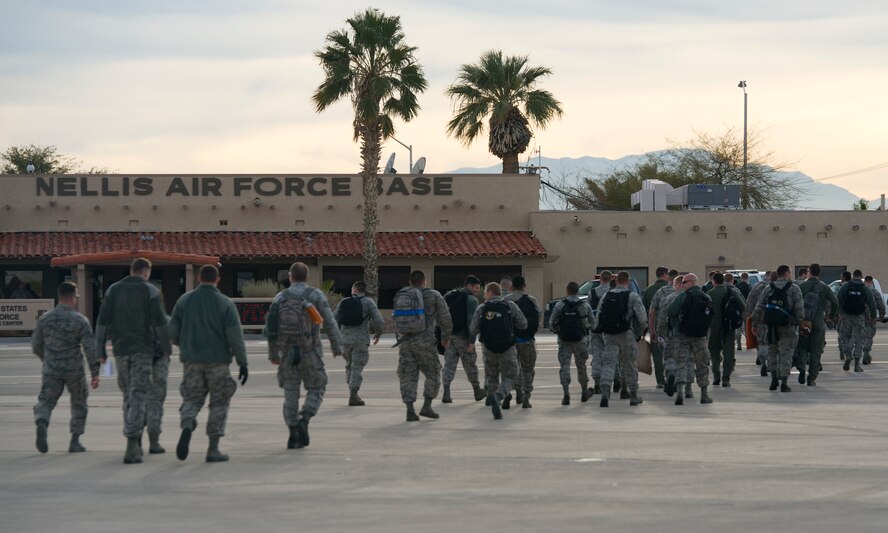 Team Tyndall members walk across the flightline Jan. 22. at Nellis AFB, Nev. The Airmen join more than 3,000 personnel from over 30 units including squadrons from Australia and the United Kingdom to participate in Red Flag 16-1. (U.S. Air Force photo by Senior Airman Alex Fox Echols III/Released)  