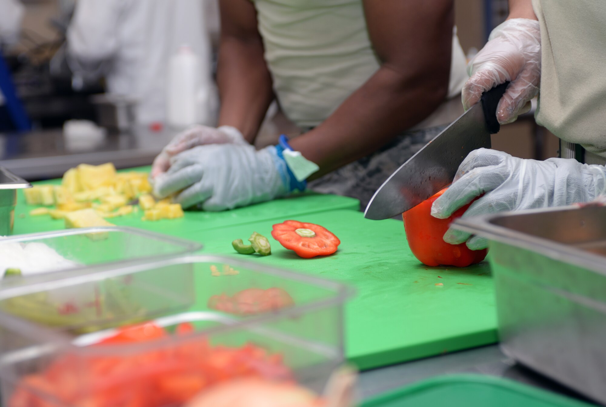 28th Force Support Squadron food services personnel prepare foods for the dinner rush hour in the Raider Café at Ellsworth Air Force Base, S.D., Jan. 25, 2016. While arranging meals, the chefs prepare food with a focus on getting the freshest foods out as quickly as possible to keep the line moving. (U.S. Air Force photo by Airman Donald C. Knechtel/Released)
