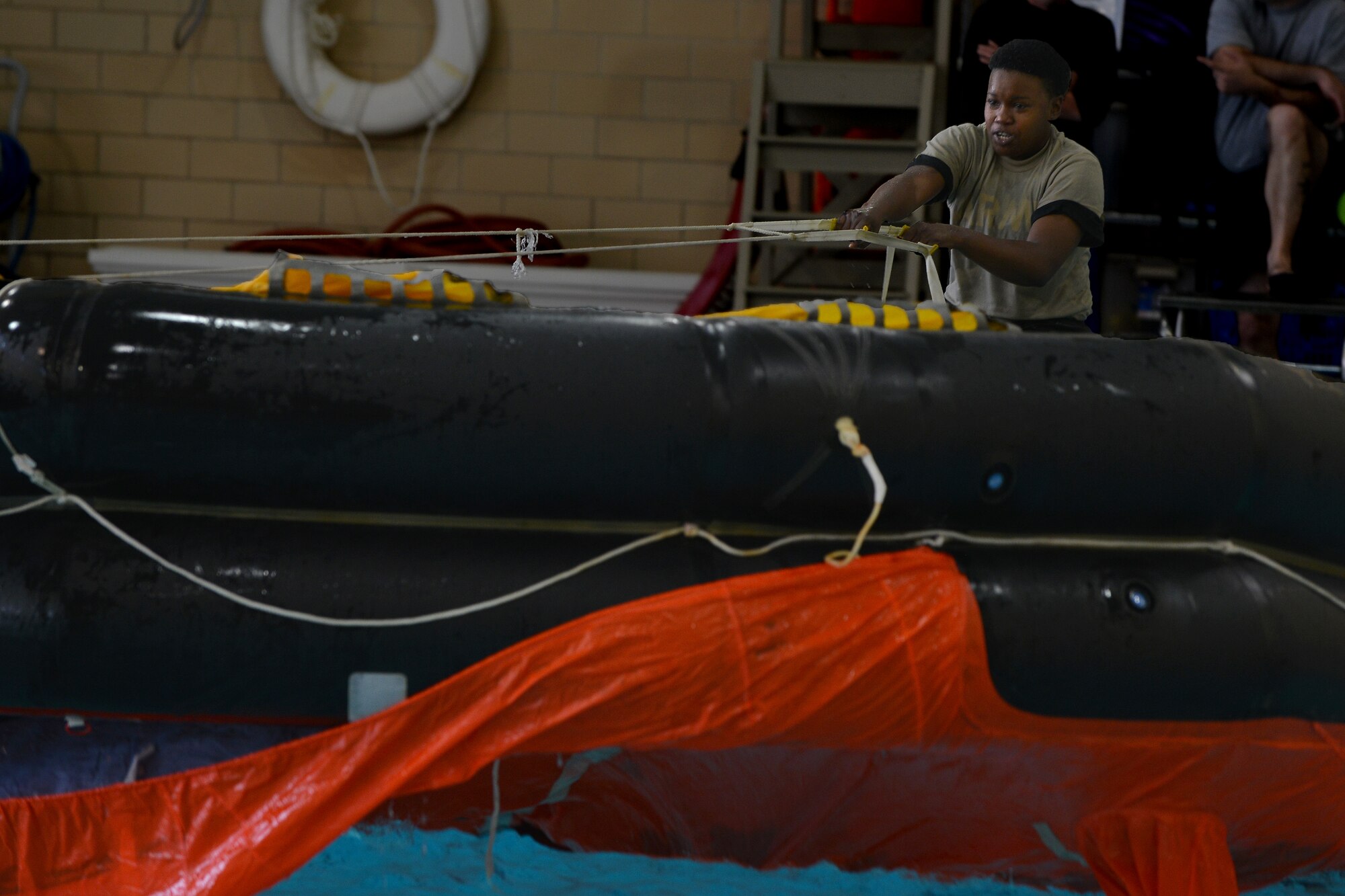 U.S. Army Pvt. Ruby Mead, a watercraft operator student with the Maritime Intermodal Training Department, pulls a 25-person life raft at Fort Eustis, Va., Jan. 26, 2016. The life raft was flipped over to simulate a scenario out at sea in which Soldiers single-handedly turn it right side up. (U.S. Air Force photo by Staff Sgt. Natasha Stannard)