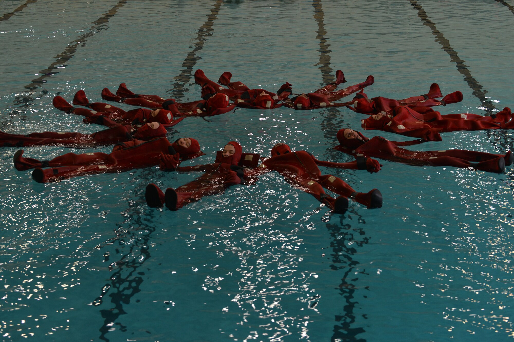 U.S. Army Soldiers swim form a circle during the survival swimming training at Fort Eustis, Va., Jan. 26, 2016. The Maritime Intermodal Training Department students practice this technique to form a large signal in the water, easily seen by rescue services, in case of an emergency evacuation. (U.S. Air Force photo by Staff Sgt. Natasha Stannard)