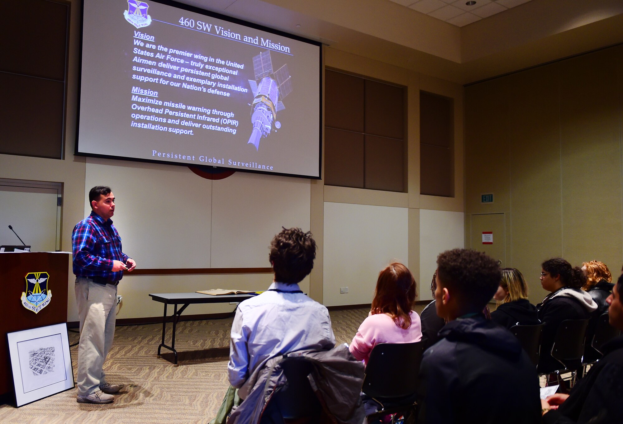 Christopher McCune, 460th Space Wing historian, talks to students from William Smith High School at the Leadership Development Center Jan. 27, 2016, on Buckley Air Force Base, Colo. The group of students visited Buckley AFB to learn about the base’s impact during World War II. (U.S. Air Force photo by Senior Airman Racheal Watson/Released)