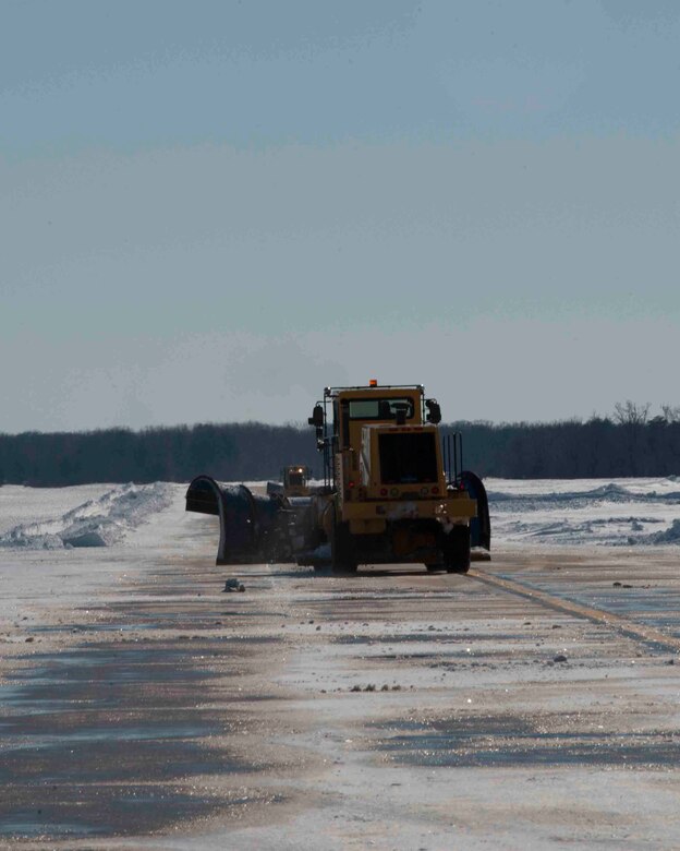 An 11th Civil Engineer Squadron snow removal vehicle drives on the flightline at Joint Base Andrews, Md., Jan. 24, 2016. The 11th CES snow removal team works nonstop from the first snowfall until the flightline is cleared. (U.S. Air Force photo by Senior Airman Dylan Nuckolls/Released)
