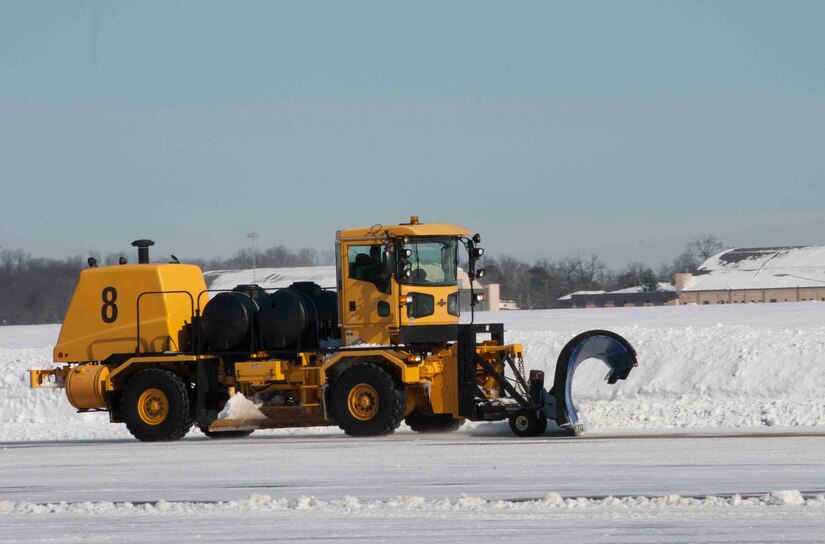 An 11th Civil Engineer Squadron snow removal vehicle plows snow on the Joint Base Andrews, Md. flightline, Jan. 24, 2016. The 11th CES snow removal team works nonstop from the first snowfall until the flightline is cleared. (U.S. Air Force photo by Senior Airman Dylan Nuckolls/Released)