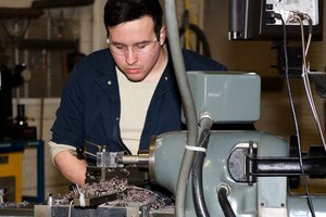 U.S. Air Force Airman 1st Class Jordan Mann, 1st Maintenance Squadron metals technician apprentice, cuts, cleans and sands welding tubes at Langley Air Force Base, Va., Jan. 25, 2016. Metal technicians can receive their welding certification in two months as part of level five upgrade training. (U.S. Air Force photo by Airman 1st Class Derek Seifert)