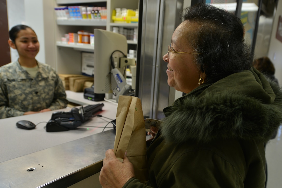 Earsey Rodrigues, a McDonald Army Health Care first-floor pharmacy customer, asks a pharmacist and technician questions about her medications at Fort Eustis, Va., Jan. 26, 2016. Before administering medication, pharmacists meet with the technicians to verify the prescription is accurately filled. (U.S. Air Force photo by Staff Sgt. Stannard)