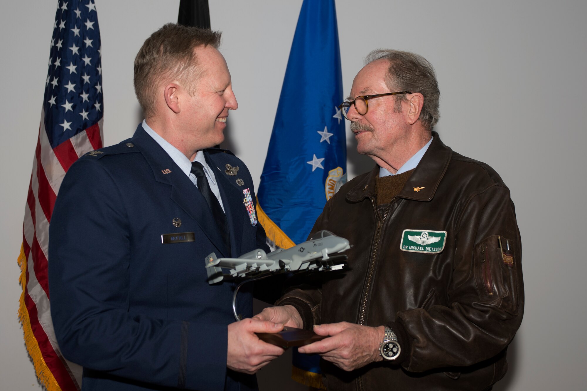 U.S. Air Force Col. Joe McFall, 52nd Fighter Wing commander, left, hands a model of a U.S. Air Force A-10 Thunderbolt II aircraft to Dr. Michael Dietszch, a 52nd FW Honorary Commander Program graduate, right, after the conclusion of the Honorary Commander's Program graduation ceremony at Club Eifel on Spangdahlem Air Base, Germany, Jan. 22, 2016. Dietzsch, also the founder of the Host Nation Council, graduated alongside 12 other honorary commanders during the ceremony. (U.S. Air Force photo by Staff Sgt. Joe W. McFadden/Released)