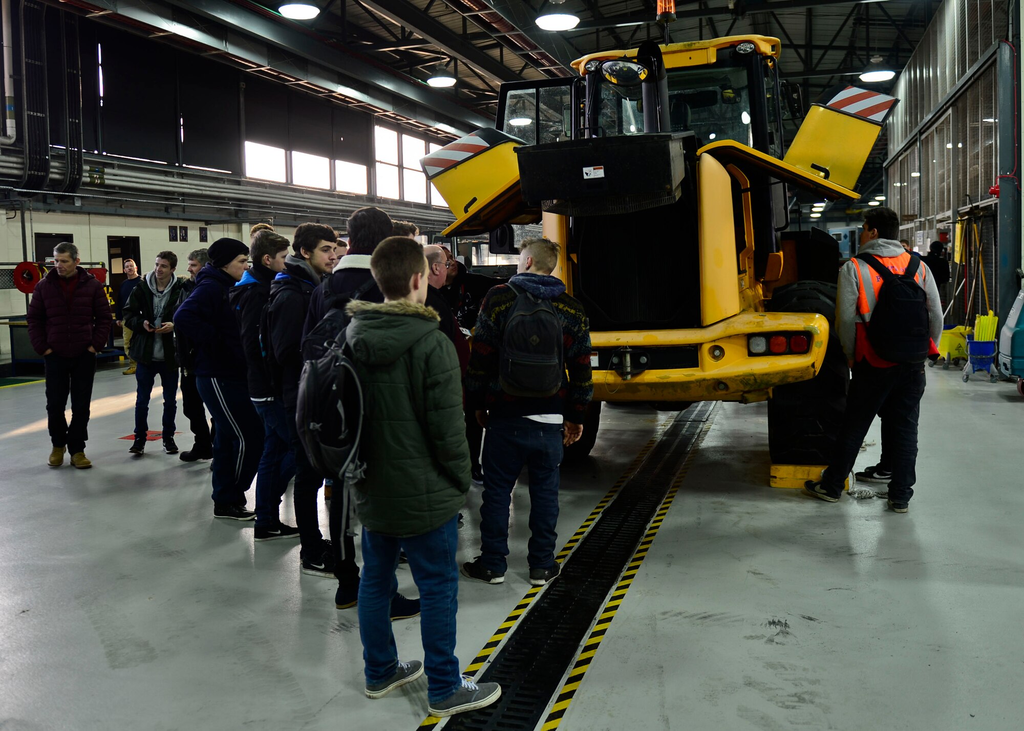 Suffolk New College students tour the vehicle maintenance section of the 48th Logistics Readiness Squadron at Royal Air Force Lakenheath, England, Jan. 20, 2016. The 24 U.K. diagnostic and recertification students spent the afternoon touring the vehicle maintenance section to see what it would be like to work on American model cars. (U.S. Air Force photo by Senior Airman Nigel Sandridge/ Released)