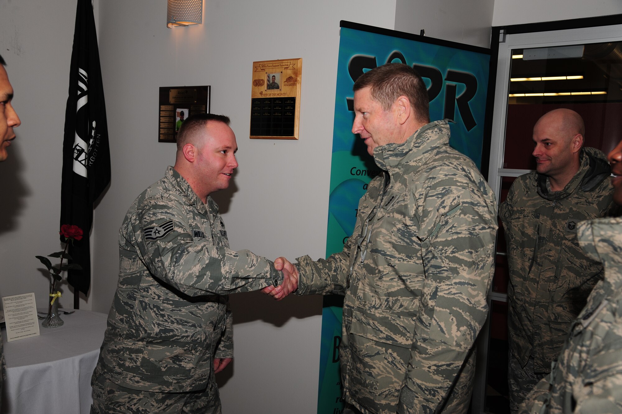 Staff Sgt. Robert L. Willis, 509th Logistics Readiness Squadron non-commissioned officer in charge of vehicle maintenance, receives a coin from Gen. Robin Rand, AFGSC commander, for his superior performance. Willis served four years as a technical instructor at Port Hueneme, Calif., and his current goal is to pursue his bachelor’s degree as an elementary school teacher. (U.S. Air Force photo by Senior Airman Keenan Berry)