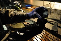 Senior Airman Max Bustamante, 22nd Maintenance Squadron non-destructive inspection Airman, checks the amount of magnetic current emanating from a part, Jan. 25, 2016, at McConnell Air Force Base, Kan. Demagnetization is a final process completed by NDI Airmen after defect identification and prevention inspections in order to send the part back to the aircraft mechanics for reinstallation. (U.S. Air Force photo/Airman Jenna K. Caldwell)  