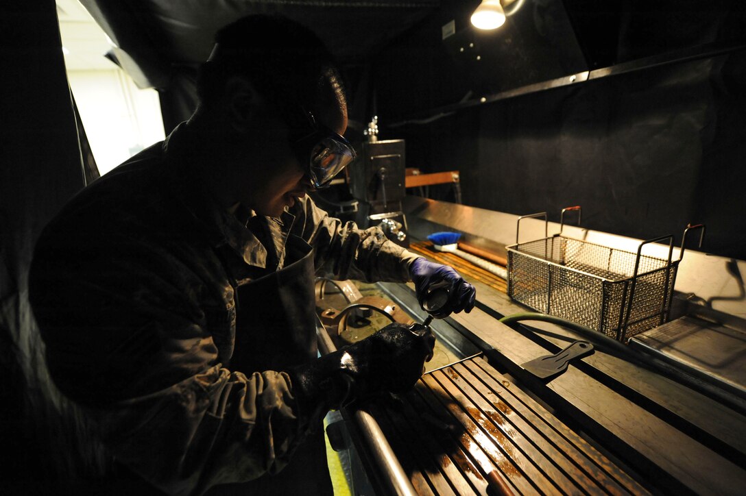 Senior Airman Max Bustamante, 22nd Maintenance Squadron non-destructive inspection Airman, checks the amount of magnetic current emanating from a part, Jan. 25, 2016, at McConnell Air Force Base, Kan. NDI Airmen run an electric current through aircraft parts to demagnetize the part so that it does not interfere with the compass on the aircraft while in flight. (U.S. Air Force photo/Airman Jenna K. Caldwell)  