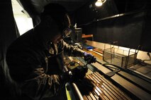 Senior Airman Max Bustamante, 22nd Maintenance Squadron non-destructive inspection Airman, checks the amount of magnetic current emanating from a part, Jan. 25, 2016, at McConnell Air Force Base, Kan. NDI Airmen run an electric current through aircraft parts to demagnetize the part so that it does not interfere with the compass on the aircraft while in flight. (U.S. Air Force photo/Airman Jenna K. Caldwell)  