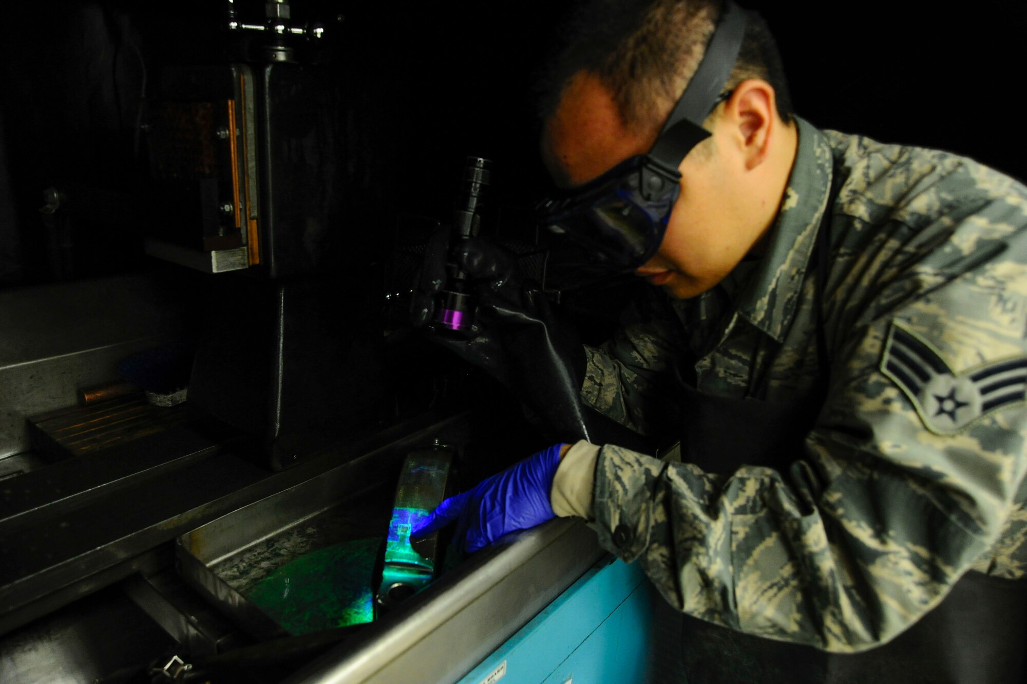 Senior Airman Max Bustamante, 22nd Maintenance Squadron non-destructive inspection Airman, dips a section of a KC-135 Stratotanker’s landing gear in phosphorus chemicals, Jan. 25, 2016, at McConnell Air Force Base, Kan. NDI Airmen perform scheduled and unscheduled maintenance inspections on aircraft parts to prevent part failures and mechanical issues and to help ensure the aircraft are in operating condition to continue the aerial refueling mission. (U.S. Air Force photo/Airman Jenna K. Caldwell)  