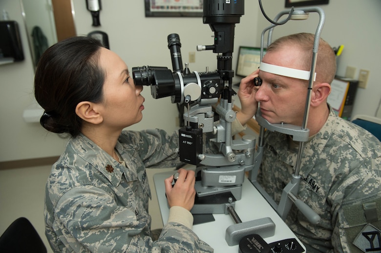 Maj. Marilyn Lai, 66th Medical Squadron optometrist, conducts an eye exam on 1st Sgt. Matthew Hitchins, 182nd Infantry Regiment operations NCO, at Hanscom Air Force Base, Mass., Jan. 26. In observance of Biomedical Sciences Corps Appreciation Week, the clinic is celebrating both clinical and non-clinical BSC career fields January 25 through 29. (U.S. Air Force photo by Jerry Saslav)