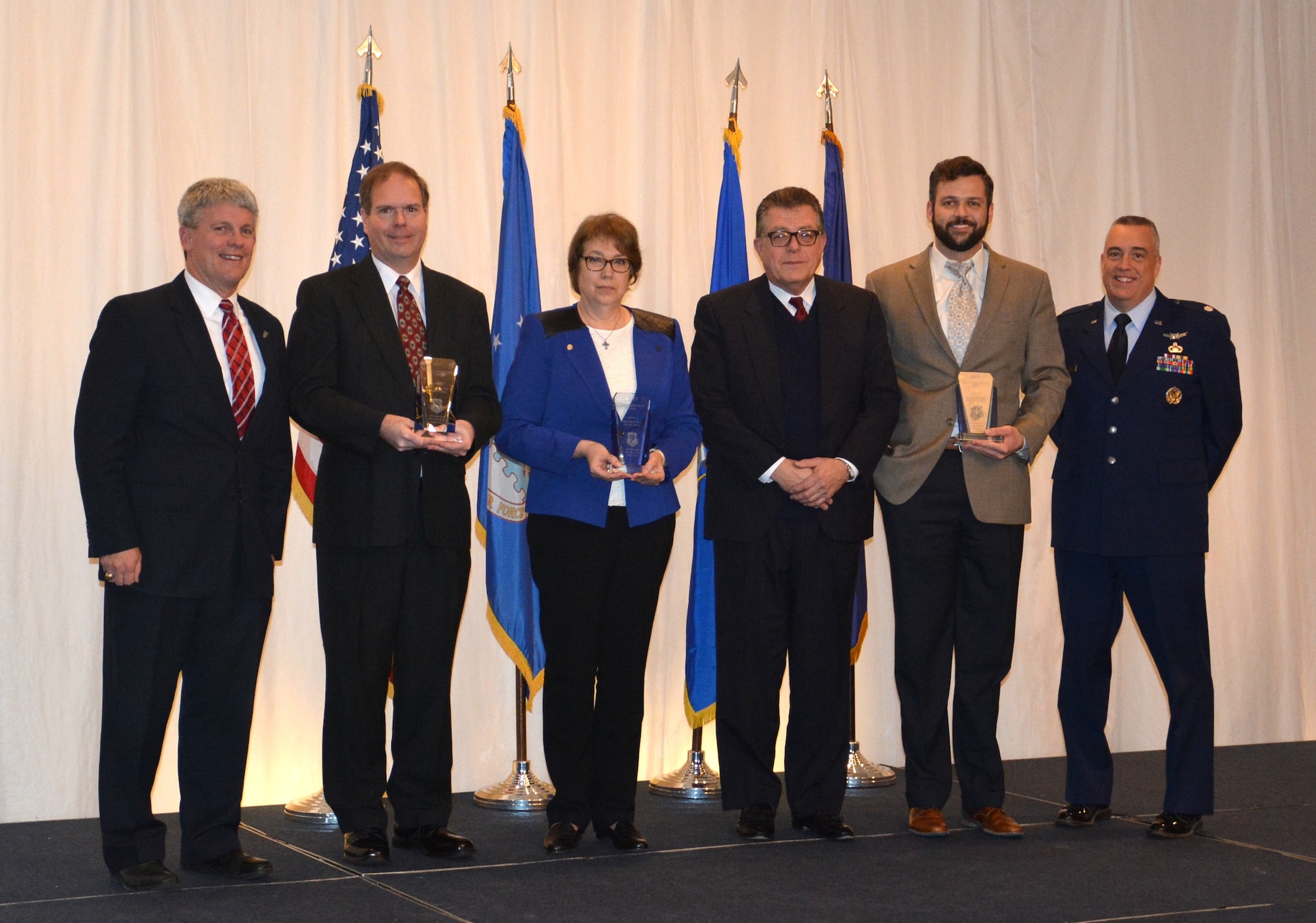 Mr. Thomas Lockhart, Director of the Materials and Manufacturing Directorate, along with Deputy Director Lt. Col. Frederick Hunt and Mr. Michael Cleary, presented the directorate’s top award, the Cleary Scientific Achievement Award, to the Multiferroics Team at the 63rd Annual Awards luncheon, held January 22, 2016.  From left to right:  Mr. Thomas Lockhart, Dr. John Jones, Dr. Gail Brown, Mr. Michael Cleary, Dr. Brandon Howe, and Lt. Col. Frederick Hunt.  (U.S. Air Force photo/David Dixon)