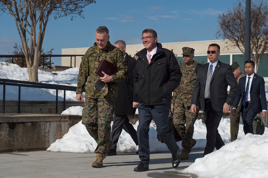 Defense Secretary Ash Carter walks with Marine Corps Gen. Joseph Dunford, chairman of the Joint Chiefs of Staff, as they return to the Pentagon after a visit to U.S. Cyber Command headquarters on Fort George G. Meade, Md, Jan. 27, 2016. The defense leaders met with Cybercom commander, Adm. Michael S. Rogers. DoD photo by Air Force Senior Master Sgt. Adrian Cadiz