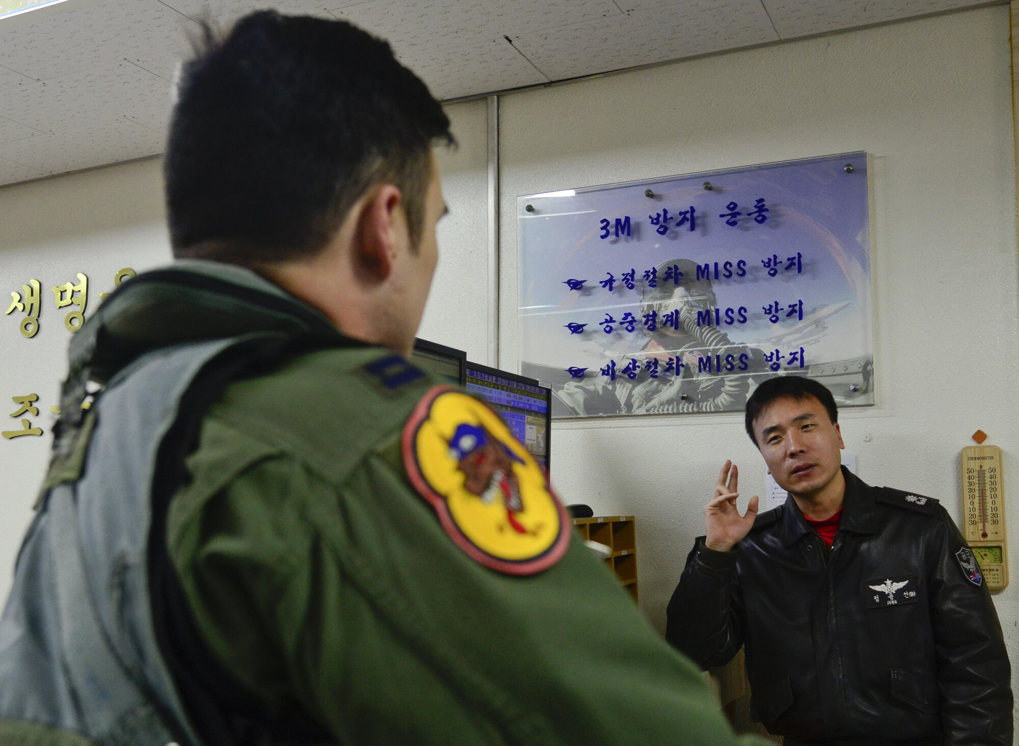 Republic of Korea air force Maj. Jung, Yong Sun (left), 121st Fighter Squadron pilot, speaks with U.S. Air Force Capt. Shannon Beers, 36th Fighter Squadron pilot, after a briefing during Buddy Wing 16-1 at Seosan Air Base, ROK, Jan. 27, 2016. The Buddy Wing exercise is a combined fighter exchange program between the U.S. and ROKAF to promote solidarity and mutual understanding of all executed operations. (U.S. Air Force photo by Senior Airman Kristin High/Released)