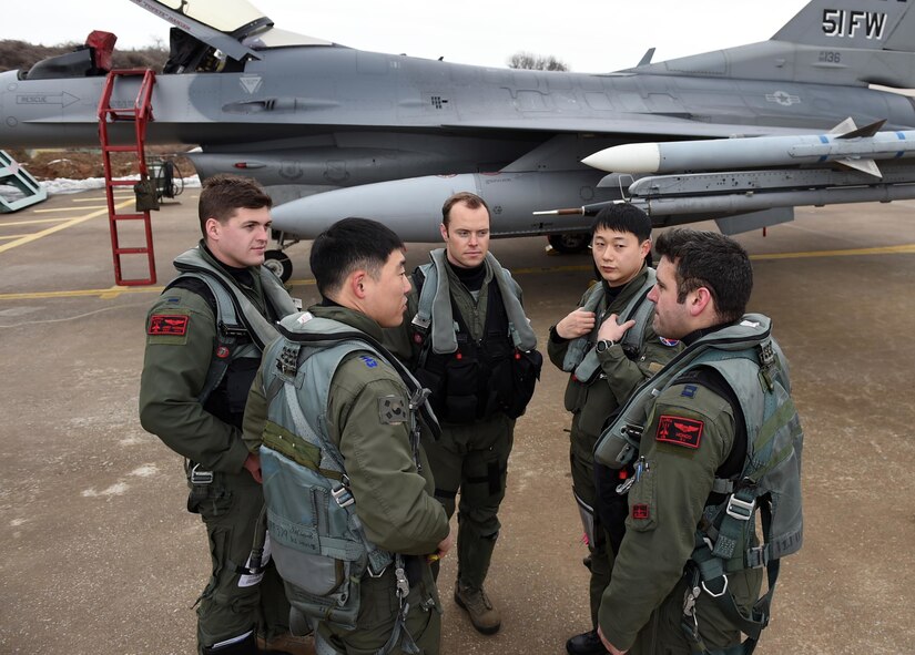 Pilots from the U.S. Air Force's 36th Fighter Squadron and the South Korean air force's 121st Fighter Squadron communicate before takeoff during exercise Buddy Wing 16-1 at Seosan Air Base,South Korea, Jan. 28, 2016. The exercise, conducted throughout the year, is used to sharpen interoperability between the allied forces. (Courtesy photo)