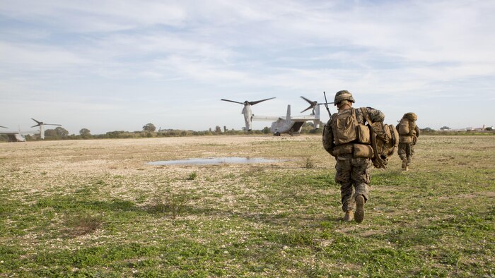 U.S. Marines with the Ground Combat Element, Special-Purpose Marine Air-Ground Task Force Crisis Response-Africa, run toward an MV-22B Osprey after recovering a simulated casualty during an alert-force drill at Naval Station Rota, Spain, January 23, 2016. SPMAGTF-CR-AF is a self-sustaining crisis-response force prepared for the protection of American personnel and facilities on the African continent when directed.