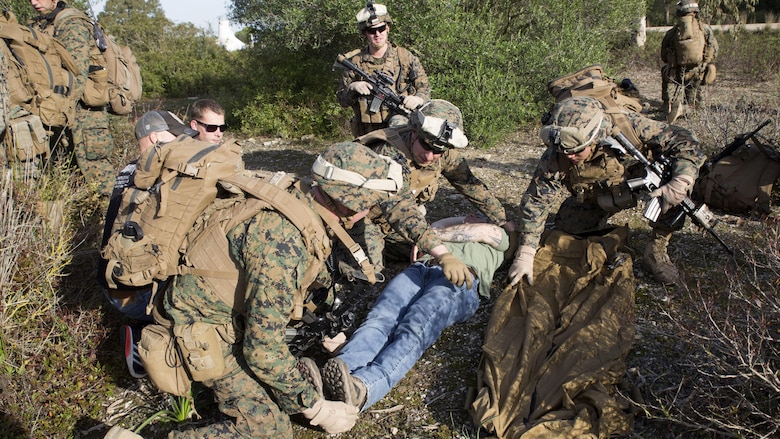 U.S. Marines with Special-Purpose Marine Air-Ground Task Force Crisis Response-Africa prepare to lift a simulated casualty onto a field litter during quick-response training at Naval Station Rota, Spain, January 23, 2016. SPMAGTF-CR-AF is a self-sustaining crisis response force prepared for the protection of American personnel and facilities on the African continent when directed.