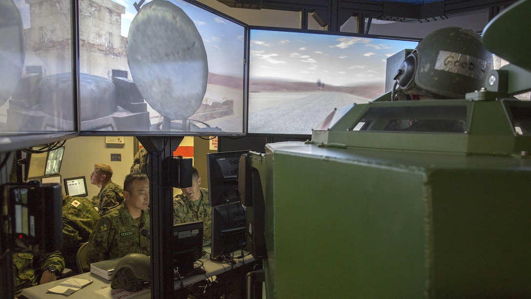 Corporal Ishida of the Japan Ground Self-Defense Force’s Western Army Infantry Regiment scans the simulated battlefield for targets as U.S. Marine Staff Sgt. Michael Casey, battalion master gunner, 3rd Assault Amphibian Battalion and simulator operator, and JGSDF Master Sgt. Fukase monitor the amphibious assault crew’s performance during Exercise Iron Fist 2016 at Marine Corps Base Camp Pendleton, Calif., Jan. 26. This annual, bilateral exercise offers the opportunity for the U.S. Marines and JGSDF soldiers to work hand-in-hand as they train and prepare for an amphibious assault being conducted on the shores of Camp Pendleton in late February.