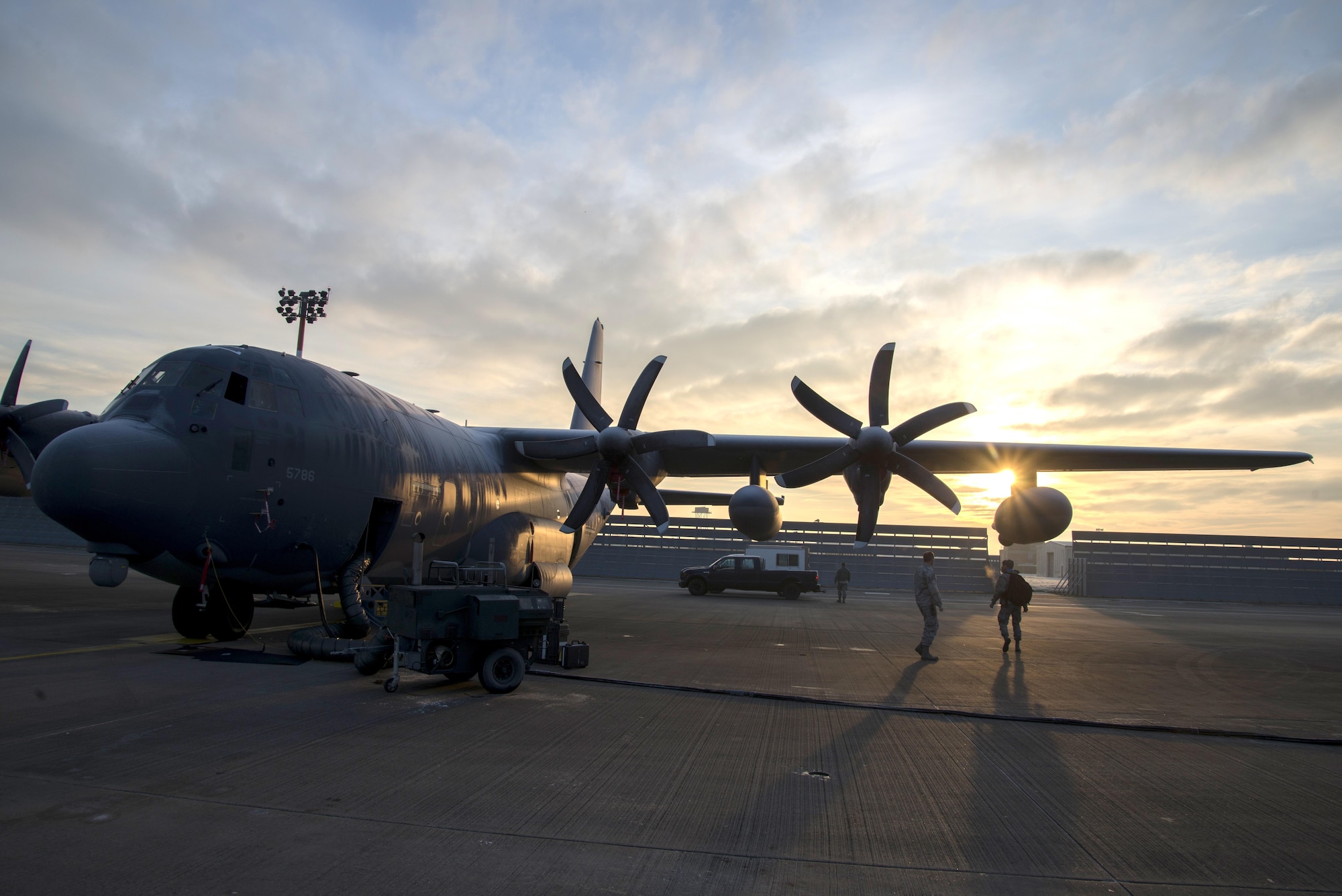 U.S. Airmen assigned to the 352d Special Operations Aircraft Maintenance Squadron perform a shift change under the wing of an MC-130J Commando II, Jan. 21, 2016 on RAF Mildenhall, England. Detailed turnover, containing aircraft and job status, is always given prior to the following shift beginning work in order to adequately support ongoing maintenance. (U.S. Air Force Photo by 1st Lt Chris Sullivan/Released)