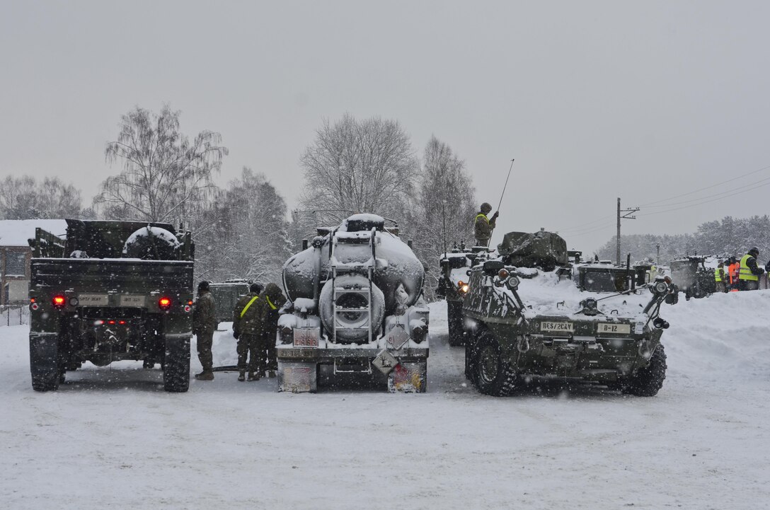 Soldiers line up their military vehicles to get fuel after being driven off the train during a railhead operation in support of Atlantic Resolve near Adazi, Latvia, Jan. 14, 2016. Army photo by Staff Sgt. Steven Colvin