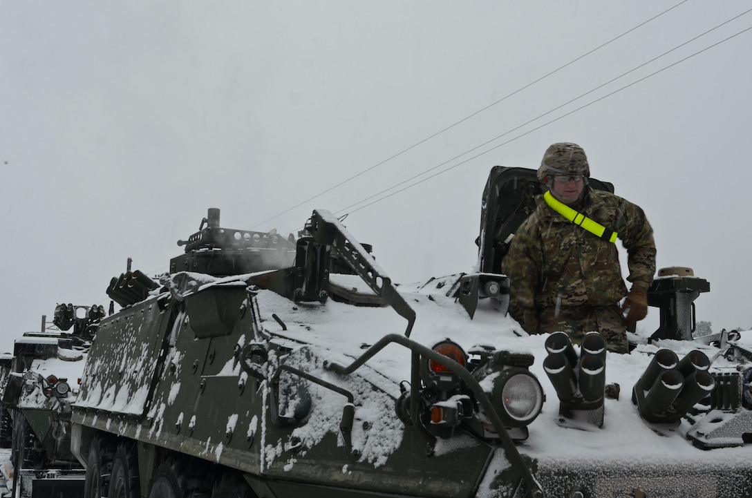 Army Spc. Christopher Armstrong prepares to drive an M1126 Stryker combat vehicle off the train during a railhead operation in support of Atlantic Resolve near Adazi, Latvia, Jan. 14, 2016. Armstrong is a forward observer assigned to the 3rd Squadron, 2nd Cavalry Regiment, deployed from Vilseck, Germany. Army photo by Staff Sgt. Steven Colvin