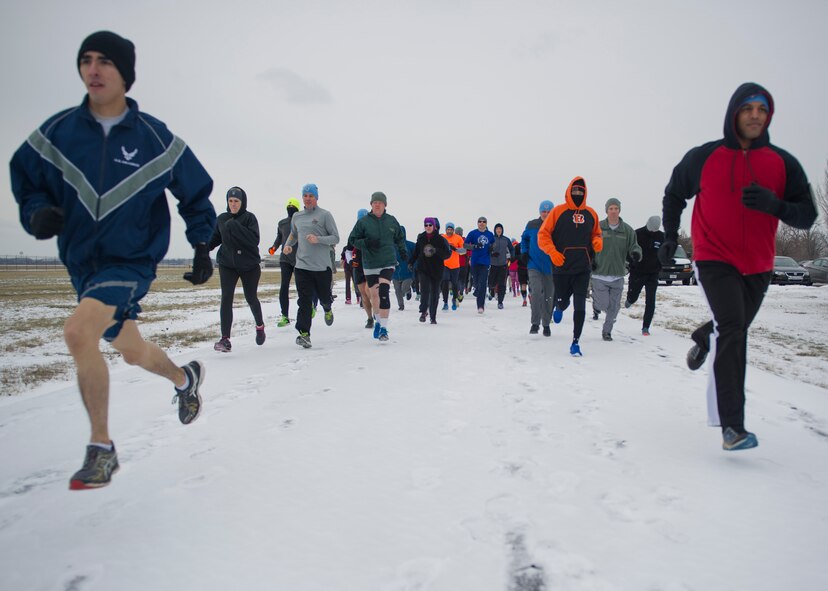 Employees of the National Air and Space Intelligence Center take off from the start line during the unit’s 3rd annual Polar Bear Run Friday, Jan. 22, 2016 on the base’s flightline running trail. This is NASIC’s third annual Polar Bear Run. The Center’s Enlisted Advisory Council sponsors the fundraiser run which uses the money for special events. (U.S. Air Force photo by Senior Airman Justyn Freeman)