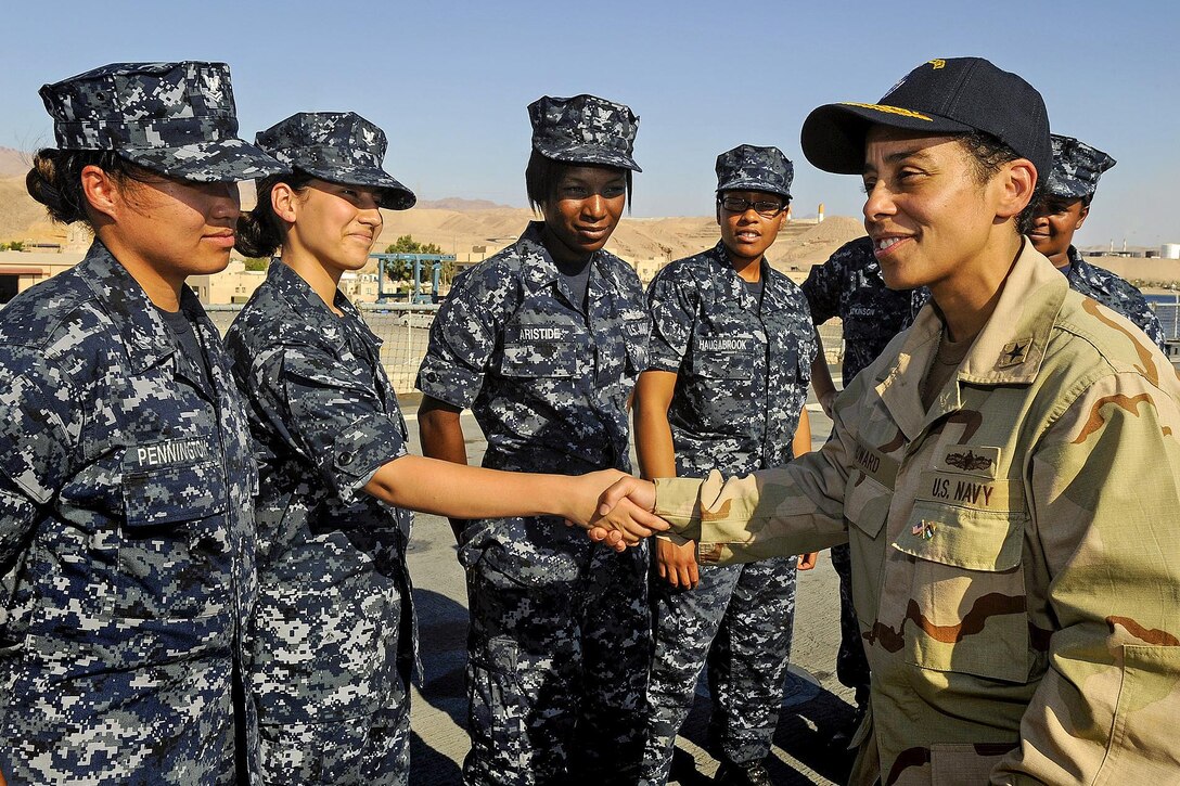Navy Adm. Michelle J. Howard, vice chief of naval operations and the first African American to command a U.S. Navy ship, shakes hands with sailors, July 7, 2009, when she was aboard the USS Fort McHenry as the commander of Expeditionary Strike Group 2.
