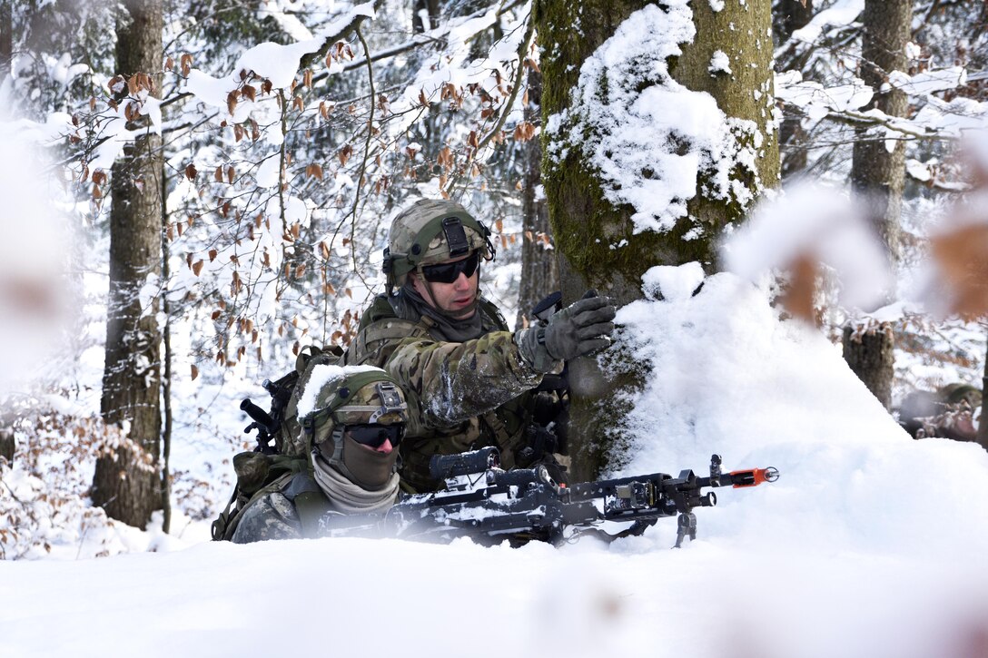 Army Spc. Bryan Giustra, right, points out different fields of fire to Army Pvt. Jacob Smith during a unit squad tactical exercise as part of Allied Spirit IV in Hohenfels, Germany, Jan. 20, 2016. Giustra is an infantryman and Smith is a gunner assigned to the 2nd Squadron, 2nd Cavalry Regiment. Army photo by Sgt. William A. Tanner