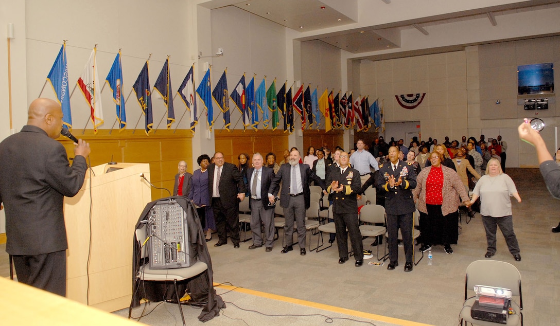 DLA Troop Support and NAVSUP Weapons Systems Support employees sing “We Shall Overcome” during a ceremony in honor of Civil Rights leader Dr. Martin Luther King, Jr. Jan. 21 in Philadelphia. Key Arts Production performed a multimedia presentation titled “King’s Dream” which outlined King’s life from childhood, his leadership in the Civil Rights Movement and assassination in 1968. 