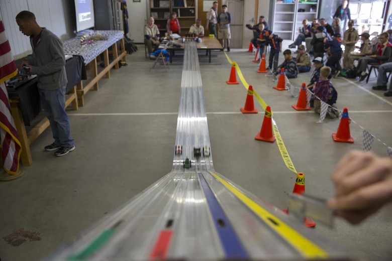 Scouts with Cub Scout Pack 78 cheer for their racecars during the annual Cub Scout Pinewood Derby at the Armed Services YMCA aboard the Combat Center, Jan. 23, 2016. (Official Marine Corps photo by Lance Cpl. Levi Schultz/Released)