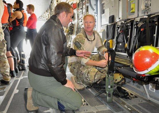 Maj. Chris Slauson, of the 45th Operations Group’s Detachment 3, discusses radio operations with Master Sgt. Jesse Stoda, of the 308th Rescue Squadron, aboard an Alaska Air National Guard C-17 Globemaster III Jan. 14, 2016, at Patrick Air Force Base, Fla. The Airmen worked together during a training event to exercise the capability of pararescuemen jumping out of C-17s to rescue distressed astronauts in the Atlantic Ocean. Their goal was to verify radio transmission and reception distances between the airborne aircraft and the astronaut in the water. (U.S Air Force photo/Chrissy Cuttita)