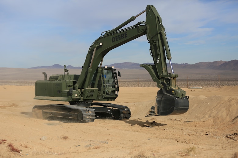 Staff Sgt. John Vasquez, heavy equipment operations chief, Marine Wing Support Squadron 374, maneuvers a John Deere 250 GR Hydraulic Excavator near the Strategic Expeditionary Landing Field, Jan. 22, 2016. The excavator enables Marines to fulfill critical engineering missions, including backhoe excavations, development of field fortifications, digging water and sewer lines, emplacement of culverts in-road, airfield construction and creating command bunkers. (Official Marine Corps Photo by Cpl. Julio McGraw/Released)