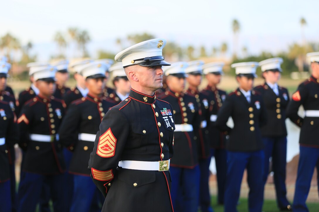 Gunnery Sgt. Antonio Soto, company first sergeant, Marine Corps Communication-Electronics School, stands at parade rest with his formation of more than 50 MCCES students during the Career Builder Challenge Military Appreciation Ceremony at the Tom Weiskopf Private Course located in the Professional Golfers Association of America Course West in La Quinta, Calif., Jan. 23, 2016. (Official Marine Corps Photo by Cpl. Julio McGraw/Released)