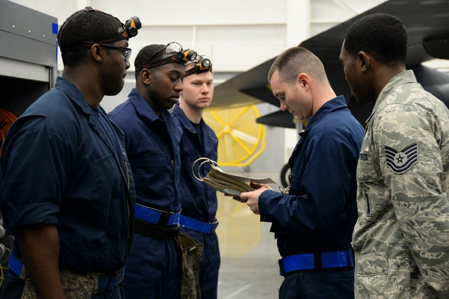Staff Sgt. Felix Passmore, 20th Aircraft Maintenance Unit weapons load crew team chief, briefs his crew before participating in the weapons load finals at Barksdale Air Force Base, La., Jan. 22, 2016. This team previously won weapons load crew of the quarter, and now competed for the title of top weapons load crew of the year. (U.S. Air Force photo/Senior Airman Amanda Morris)
