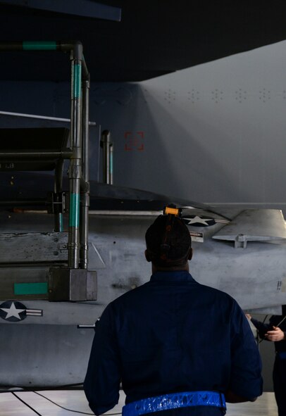 A weapons load crew team member from the 20th Aircraft Maintenance Unit ensures that a pylon loaded with an AGM-86B nuclear training munition is in line with the aircraft before loading the munition during the weapons load finals at Barksdale Air Force Base, La., Jan. 22, 2016. Prior to raising the MHU-196 trailer the crew member ensures that the munition is lined-up correctly with the aircraft, allowing him to make as few movements as possible when connecting the munition to the aircraft. (U.S. Air Force photo/Senior Airman Amanda Morris)