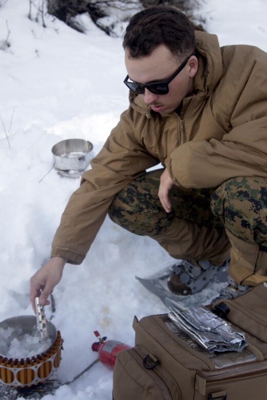 Cpl. Dustin B. Moore boils water for his Marines during cold weather training at Marine Corps Mountain Warfare Training Center, Calif., Jan. 11, 2016. The cold weather training done in the Sierra Mountains is a warm-up to Exercise Cold Response 2016 in Norway. More than 800 Marines participated in the two-week-long exercise that taught basic mobility in snow, defensive and offensive tactics as well as basic cold weather and high altitude conditions training. 2nd Low Altitude Air Defense Battalion provides anti-air warfare support for the Marine Air Ground Task Force. Moore is a team leader with 2nd LAAD Bn.’s B Battery. (U.S. Marine Corps photo by Cpl. Jason Jimenez/Released)