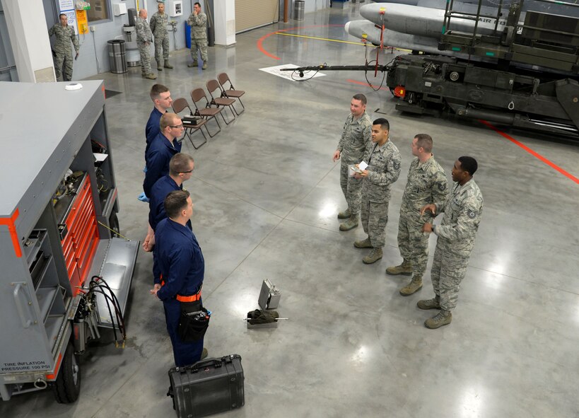 Loading standardization crew members brief the 96th Aircraft Maintenance Unit weapons load crew team on rules and regulations before the weapons load finals at Barksdale Air Force Base, La., Jan. 21, 2016. The competition was based on a point system, each team began with 1,000 points and then were scored on dress and appearance, a B-52 Stratofortress weapon system and air munitions test, equipment inspection, and weapons loading technical operations. (U.S. Air Force photo/Senior Airman Amanda Morris) 
