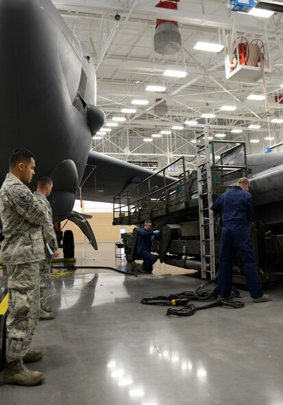 Weapons load crew team members from the 96th Aircraft Maintenance Unit prep an MHU-196 trailer for loading during the weapons load finals at Barksdale Air Force Base, La., Jan. 21, 2016. The trailer safely transports munitions such as the AGM-86B, a nuclear training munition, to and from aircraft. (U.S. Air Force photo/Senior Airman Amanda Morris)