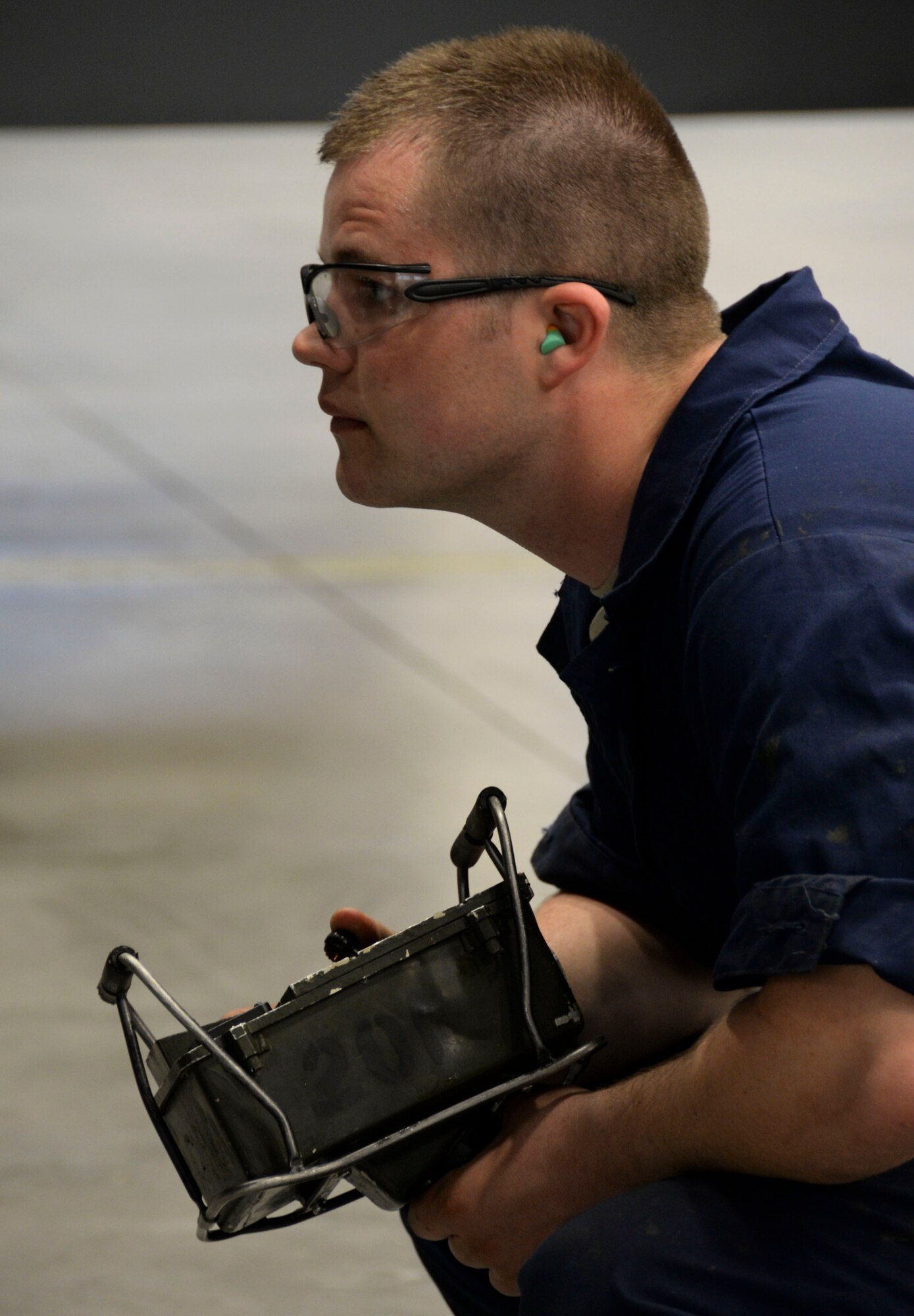 Senior Airman David Hansen, 96th Aircraft Maintenance Unit weapons load crew team member, operates a power control unit during the weapons load finals at Barksdale Air Force Base, La., Jan. 21, 2016. Prior to raising an MHU-196 weapon trailer, Hansen ensured the munition was lined-up correctly to connect the munition to a B-52 Stratofortress. (U.S. Air Force photo/Senior Airman Amanda Morris)