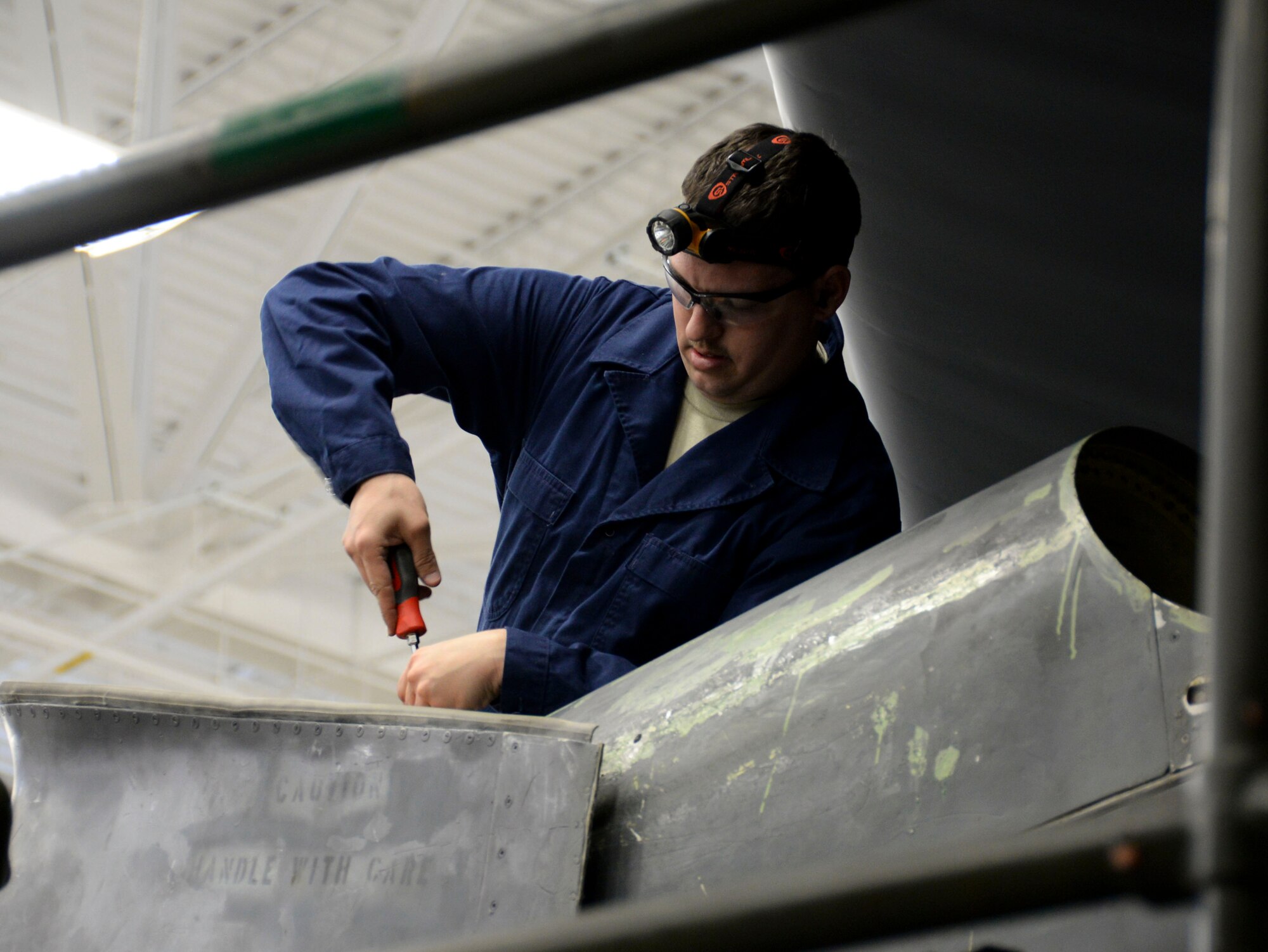 Staff Sgt. Adolfo Trujillo, 96th Aircraft Maintenance Unit weapons load crew team chief, installs a fitting to a B-52 Stratofortress forward buffet fairing during the weapons load finals at Barksdale Air Force Base, La., Jan. 21, 2016. The forward buffet fairing assists with the aerodynamics of the aircraft. (U.S. Air Force photo/Senior Airman Amanda Morris)