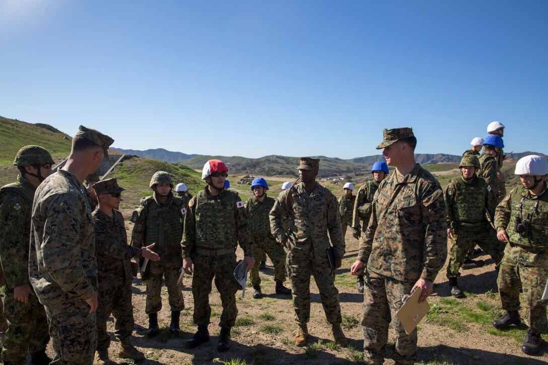 U.S. Marines and their Japan Ground Self-Defense Force Soldiers discuss the layout of Range 223B, a platoon attack range, aboard Marine Corps Base Camp Pendleton, Calif., Jan. 25, 2016. U.S. Marines facilitated the use of the range acting as safety personnel per base regulations, to allow the Japanese soldiers to hone some of the fundamental skills and techniques they would be using throughout Exercise Iron Fist 2016.