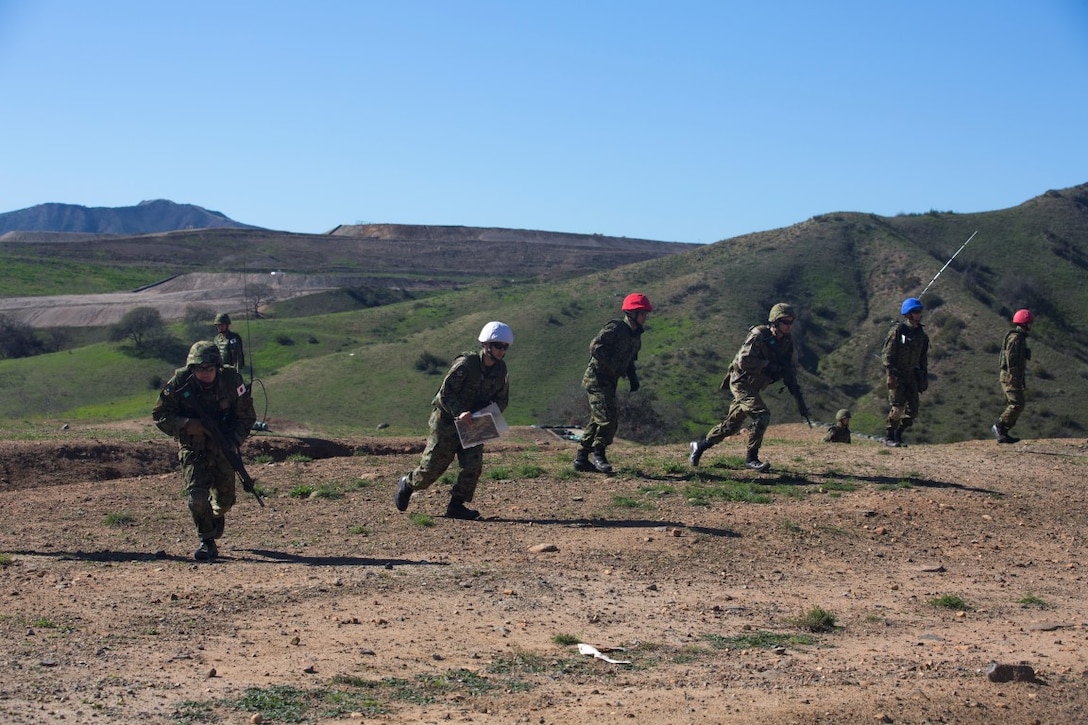Japan Ground Self-Defense Force soldiers bound to a new position while rehearsing for a platoon attack exercise aboard Marine Corps Base Camp Pendleton, Calif., Jan. 25, 2016. This platoon attack exercise was the first of several training exercises that soldiers of the Japan Ground Self-Defense Force will be conducting as a part of Exercise Iron Fist 2016.