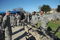 Senior Airman Reshawn Hill (left) and Technical Sgt. Jermaine, 802nd Security Forces Squadron security forces specialists, briefs Lt. Gen. Darryl Roberson, Commander of Air Education and Training Command, on the different weapons systems they employ at the 802nd SFS Jan. 21, Joint Base San Antonio-Lackland.  Roberson was provided a 502nd Air Base Wing immersion tour where he visited units throughout JBSA-Randolph, Lackland and Fort Sam Houston, Jan. 20-22.  The 502nd ABW is responsible for installation support across all JBSA locations.  (U.S. Air Force photo by Joel Martinez)