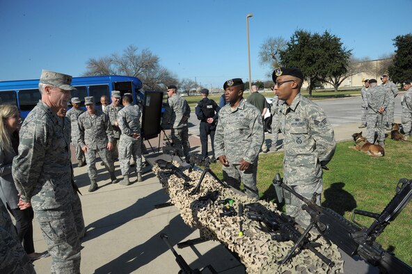 Senior Airman Reshawn Hill (left) and Technical Sgt. Jermaine, 802nd Security Forces Squadron security forces specialists, briefs Lt. Gen. Darryl Roberson, Commander of Air Education and Training Command, on the different weapons systems they employ at the 802nd SFS Jan. 21, Joint Base San Antonio-Lackland.  Roberson was provided a 502nd Air Base Wing immersion tour where he visited units throughout JBSA-Randolph, Lackland and Fort Sam Houston, Jan. 20-22.  The 502nd ABW is responsible for installation support across all JBSA locations.  (U.S. Air Force photo by Joel Martinez)